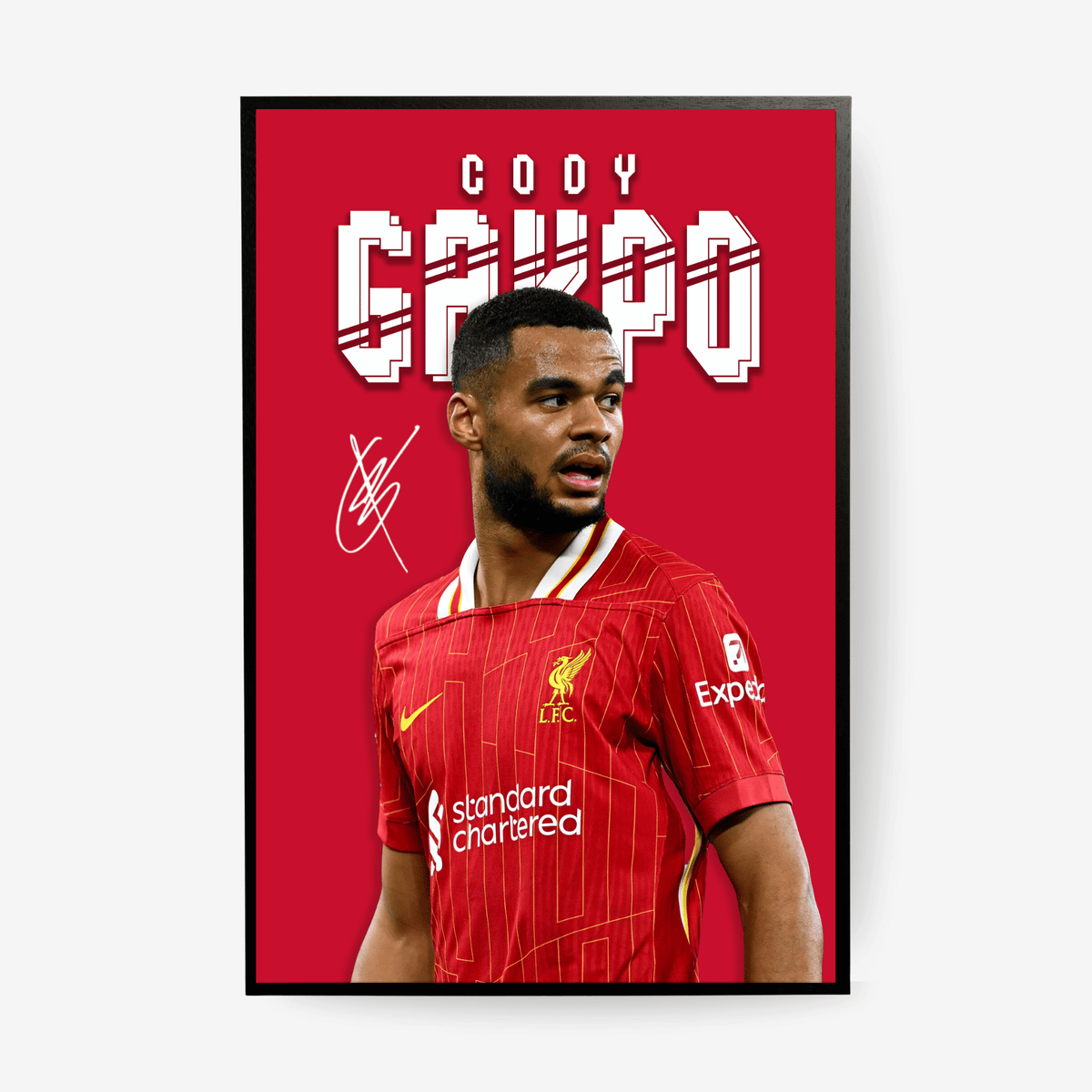 Framed poster of a soccer player in a red jersey with 'Standard Chartered' and 'Experian' logos on a red background.