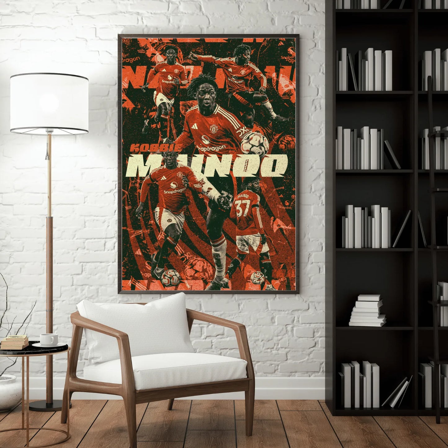 Framed Kobbie Mainoo football poster hanging in a modern living room with white brick wall and bookshelf