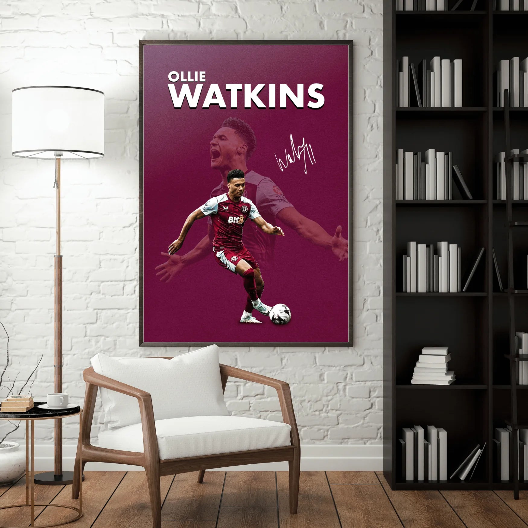 Interior room scene with large framed Ollie Watkins poster on brick wall beside bookshelf and chair.